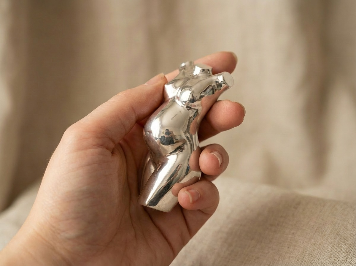A silver mini, held in the palm of a hand